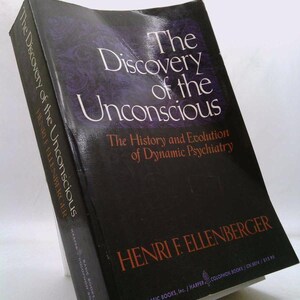 May include: A hardcover book titled "The Discovery of the Unconscious" by Henri F. Ellenberger. The book has a black cover with white and orange text. The title is prominently displayed with a purple and black background.