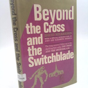 May include: A book cover with a pink background and the title "Beyond the Cross and the Switchblade" in white text. The author's name, "David Wilkerson", is listed below the title, along with a special introduction by John and Elizabeth Sherrill. The book is a follow-up to the best-selling book "The Cross and the Switchblade".
