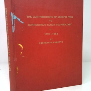 May include: A red hardcover book titled "The Contributions of Joseph Ives to Connecticut Clock Technology." The book's spine reads "Connecticut Clock Technology of Joseph Ives." The publication covers the years 1810-1862 and is by Kenneth D. Roberts.