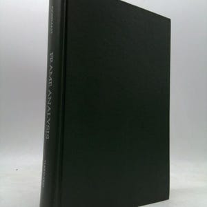 May include: A hardcover book titled "Frame Analysis" by Erving Goffman. The book has a dark green cover with the title and author's name printed vertically on the spine. The publisher's name, Harvard, is also printed on the spine.