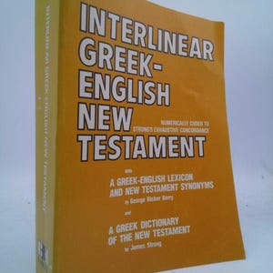 May include: A yellow book titled "Interlinear Greek-English New Testament" with the text "Numerically coded to Strong's Exhaustive Concordance" and the names of the authors, George Ricker Berry and James Strong.
