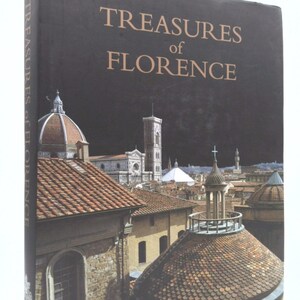 May include: A book titled "Treasures of Florence" with a photo of the city skyline on the cover. The photo shows the Duomo, the Basilica di San Lorenzo, and other buildings with terracotta tile roofs.