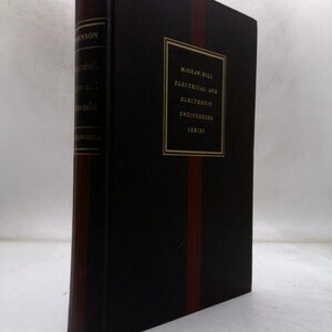 May include: A dark brown hardcover book with a vertical red stripe on the front cover. The front cover features a gold-bordered box with the text McGraw-Hill Electrical and Electronic Engineering Series. The spine includes gold lettering and lines.