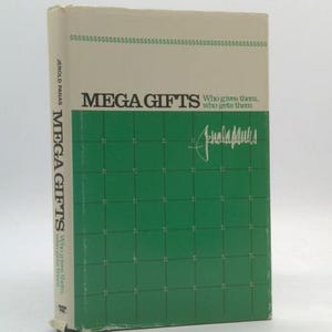 May include: A hardcover book titled "MEGA GIFTS" with a green grid pattern on the cover. The book's spine reads "MEGA GIFTS" vertically. The cover also features the author's signature and the text "Who gives them, who gets them."
