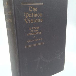 May include: A black hardcover book titled The Patmos Visions: A Study of the Apocalypse by Philip Mauro. The front cover features gold lettering and a decorative border. The spine shows signs of wear at the top edge and includes the title.