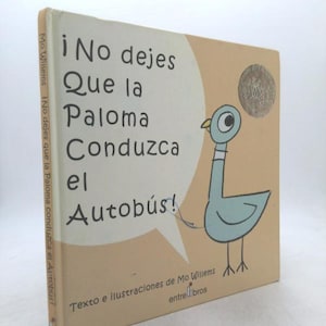 May include: A children's book titled "¡No dejes Que la Paloma Conduzca el Autobús!" features a light blue pigeon illustration. The cover has text in Spanish and a speech bubble. The book is by Mo Willems.