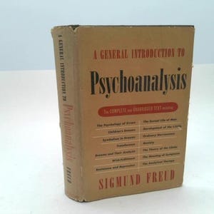 May include: A vintage hardcover book titled "A General Introduction to Psychoanalysis" by Sigmund Freud. The book has a tan cover with red and black text. The spine reads "Psychoanalysis" vertically.