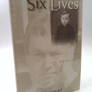 May include: A book titled "Six Lives: A Memoir" by Dow Marmur. The cover features a black and white photo of a man and a smaller black and white photo of a young boy.