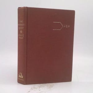 May include: A hardcover book titled "The Robinson Quest" by Allan Q. Masel. The book has a reddish-brown cover with gold lettering and a geometric design on the front. The book is standing upright against a white background.