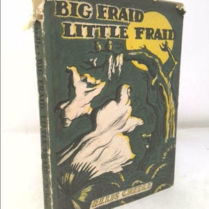 May include: A vintage book cover with a green background and a yellow moon. The title is "Big Fraid Little Fraid" with the author's name "Ellis Credle" at the bottom. The cover features a spooky illustration of ghosts and owls in a forest.