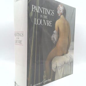 May include: A hardcover book titled "Paintings in the Louvre" by Lawrence Gowing. The cover features a nude figure with a head covering. The book's spine displays the title and the publisher's name, "Gowing."