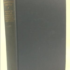 May include: A hardcover book titled "The Complete Psychological Works of Sigmund Freud" with a dark green cover. The spine displays the title and author in gold lettering, with "Standard Edition" at the bottom. The book is a volume from 1912-1913.