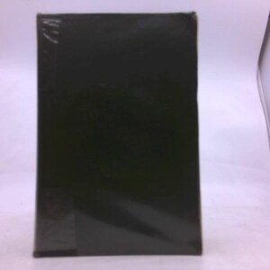 May include: A rectangular, dark green object, possibly a book or a box, is wrapped in clear plastic. The object is positioned against a white background, with the plastic wrap reflecting the surrounding light.