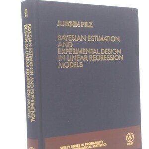May include: A hardcover book titled "Bayesian Estimation and Experimental Design in Linear Regression Models" by Jurgen Pilz. The book has a dark blue cover with gold lettering and a brown stripe at the bottom. The Wiley logo is visible.
