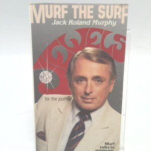 May include: A book cover featuring the title "MURF THE SURF" and author Jack Roland Murphy. The cover has a portrait of a man in a suit, with text that reads "for the journey" and "Murf talks to wiseguys."