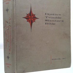 May include: A green book titled "Doolin's Trouble Shooters Bible" with a red compass on the front cover. The book is published by Doolco, Inc.