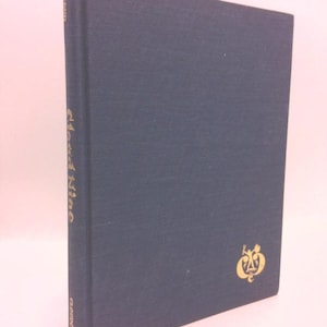 May include: A dark blue hardcover book with the title "Cloud Nine" in gold lettering on the spine. The book has a gold embossed design on the front cover.