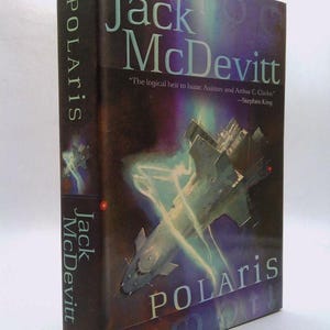 May include: A book cover with a dark blue background and a spaceship in the center. The title "Polaris" is written in white letters on the cover. The author's name, "Jack McDevitt", is written in white letters on the spine. The quote "The logical heir to Isaac Asimov and Arthur C. Clarke." is written in white letters on the cover. The quote is attributed to Stephen King.