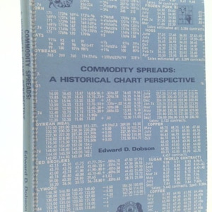 May include: A blue and white chart with the title "Commodity Spreads: A Historical Chart Perspective". The chart shows historical prices for various commodities, including wheat, corn, oats, soybeans, soybean meal, broilers, plywood, silver, potatoes, frozen pork bellies, hogs, sugar, copper, coffee, and cocoa.
