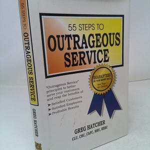 May include: A white book titled "55 Steps to Outrageous Service." The cover features the title in large, bold letters with an orange and yellow background. The book also includes the author's name, Greg Hatcher, and a guarantee seal.