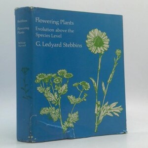 May include: A hardcover book titled "Flowering Plants" with a blue cover. The cover features illustrations of white and green flowers and the text "Evolution above the Species Level" and the author's name, G. Ledyard Stebbins.