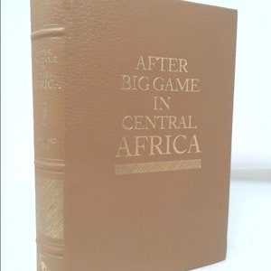 May include: A brown leather-bound book with gold lettering on the spine. The title is "After Big Game in Central Africa".