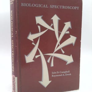 May include: A maroon hardcover book titled "Biological Spectroscopy" by Iain D. Campbell and Raymond A. Dwek. The cover features a white abstract design of arrows.