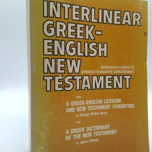 May include: A vintage book titled "Interlinear Greek-English New Testament" with text in white and black on a yellow cover. The book includes a Greek-English lexicon and New Testament synonyms by George Ricker Berry.