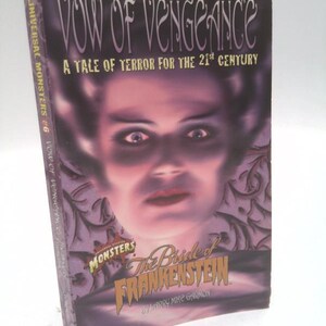 May include: A paperback book titled Vow of Vengeance: A Tale of Terror for the 21st Century, featuring a purple-toned illustration of a face with dark hair and the text The Bride of Frankenstein by Larry Mike Garmon on the cover.