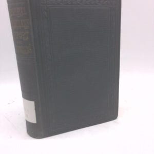 May include: A dark green hardcover book with gold lettering on the spine. The book has a textured cover and a decorative border. A white label is affixed to the spine. The book appears to be an antique or vintage edition.