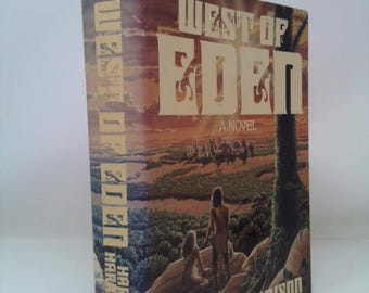 May include: A vintage paperback book titled "West of Eden: A Novel" by Harry Harrison. The cover features a landscape illustration with two figures and the title in large, stylized letters. The book has visible wear and tear.