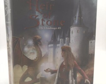 May include: A hardcover book titled "Heir of Stone" by S.L. Farrell. The cover features a dragon, a woman in a red dress, and a castle. The book is part of "The Cloudmages" series.