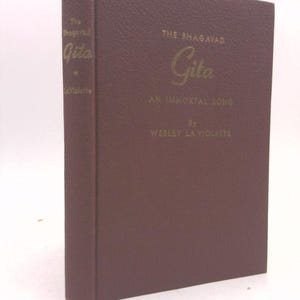May include: A burgundy leather-bound book titled "The Bhagavad Gita: An Immortal Song" by Wesley La Violette.