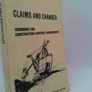 May include: A vintage book titled "Claims and Changes" with the subtitle "Handbook for Construction Contract Management." The cover is a light beige with black text and a black and white illustration of construction equipment.