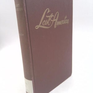 May include: A brown hardcover book with the title "Lost America" in gold lettering on the front cover.