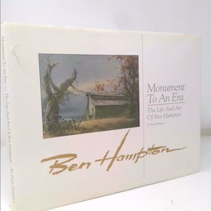 May include: A hardcover book titled "Monument To An Era: The Life And Art Of Ben Hampton." The cover features a landscape painting with a weathered building and a tree. The title and artist's name are in gold lettering.