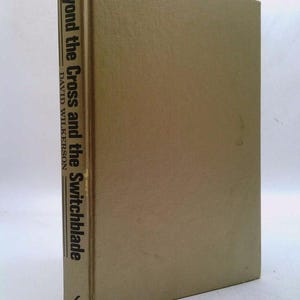 May include: A tan hardcover book with the title "Beyond the Cross and the Switchblade" by David Wilkerson. The book is published by Chosen Books.