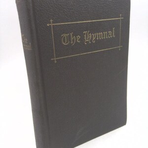 May include: A black leather-bound book with gold lettering that reads "The Hymnal".