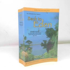 May include: A paperback book titled Back to Eden by Jethro Kloss, featuring a blue cover with a landscape illustration of a lake and trees. The text reads Over Five Million Sold, The Authentic Kloss Family, and The Classic Guide to Herbal Medicine.