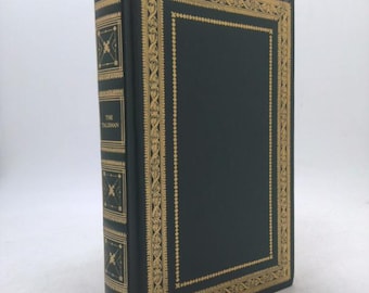 May include: A green hardcover book with a gold decorative border and the title "The Talisman" by Sir Walter Scott.