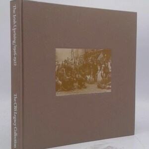May include: A hardcover book titled "The Irish Uprising/1916-1922" from The CBS Legacy Collection. The book has a brown cover with a sepia-toned photograph of a group of people. The spine displays the title.