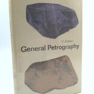 May include: A vintage book titled "General Petrography" by V. Zubkov. The cover features two abstract rock illustrations in purple and brown against a beige background. The book's spine is visible, showing the title and author.