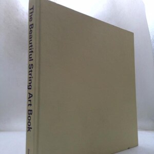 May include: A hardcover book titled The Beautiful String Art Book with a plain light beige cover. The spine features the title in dark text and the publisher name Sterling at the bottom. The book is positioned upright to show the front cover.