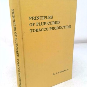 May include: A yellow book titled "Principles of Flue-Cured Tobacco Production" by S. N. Hawks, Jr.