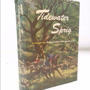 May include: A vintage book cover with a green, brown, and yellow illustration of a tree and two people riding horses. The title of the book is "Tidewater Sprig" and the author is Robert Emmett McDowell.