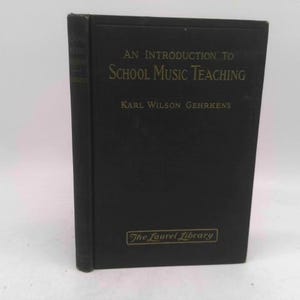 May include: A black hardcover book titled "An Introduction to School Music Teaching" by Karl Wilson Gehrkens. The book is part of "The Laurel Library" series. The text is in gold lettering.