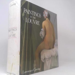 May include: A hardcover book titled "Paintings in the Louvre" by Lawrence Gowing. The book cover features a painting of a nude figure seated on a white cushion against a backdrop of green drapery.