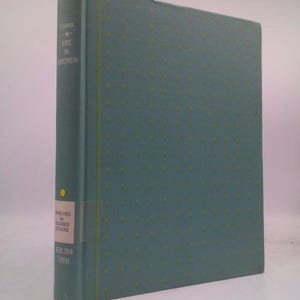 May include: A hardcover book titled "Fire in America" by Lyons. The book has a teal cover with a repeating yellow dot pattern. The spine is teal with white text. A white sticker with black text is on the spine.