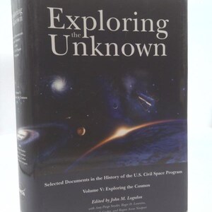 May include: A hardcover book titled "Exploring the Unknown" with a dark blue cover featuring a space-themed illustration. The book is Volume V in a series about the U.S. Civil Space Program, edited by John M. Logsdon.
