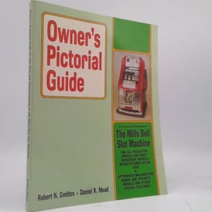 May include: A vintage book titled "Owner's Pictorial Guide" with a red and white title on a light green cover. The book features an image of a red slot machine and text about the Mills Bell Slot Machine.